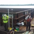 Photo of USGS and FWS scientists studying the interaction of moving barges and small fish on the Illinois Waterway.