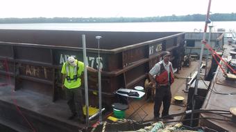Photo of USGS and FWS scientists studying the interaction of moving barges and small fish on the Illinois Waterway.